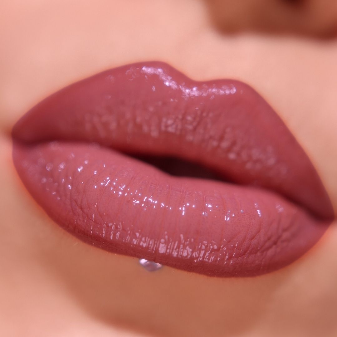 Close-up of glossier lipstick on lips with lip liner and lip gloss.