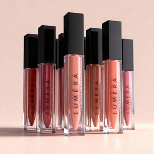 Luméra lip glosses on a beige background