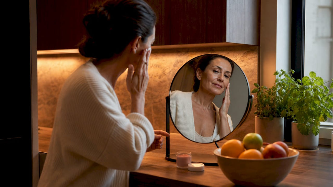 Woman over 40 applying makeup at vanity