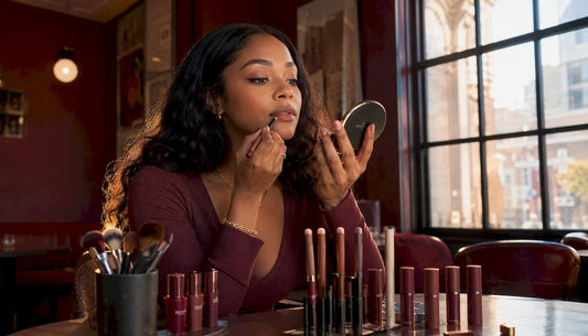 Light brown skin woman applying NYX lip liner