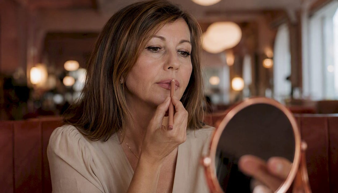 Applying subtle nude lip liner on top lip center