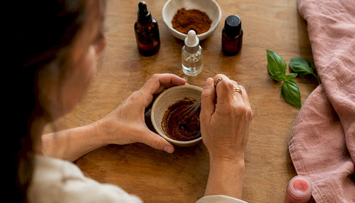 Hands mixing DIY lip plumper ingredients