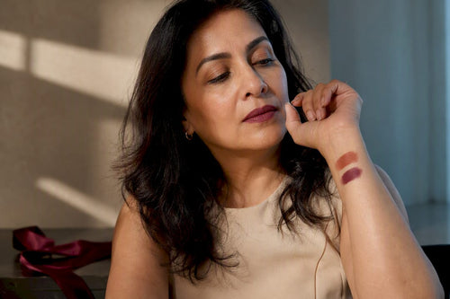 Mature woman comparing terracotta and blue berry swatches