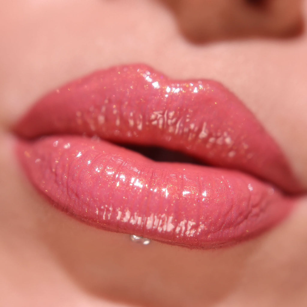 Close-up of Miss Sassy Pink glossy pink lips Shimmer Lip Gloss with a blurred background