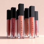 Luméra lip glosses on a beige background